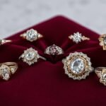 Collection of antique engagement rings from different eras displayed on vintage velvet