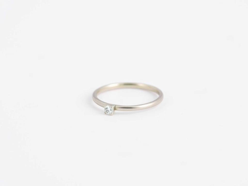 Minimalist silver engagement ring with a simple band and subtle stone