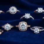 Various engagement rings displayed on a velvet background showing different styles and diamond cuts