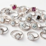 Various silver engagement rings displayed on a white background showing different styles and stone settings
