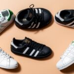 Collection of popular Adidas shoe styles including Sambas, Stan Smiths, and Superstars arranged on a neutral background