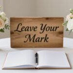 A beautifully arranged wedding guest book display with calligraphy sign and flowers