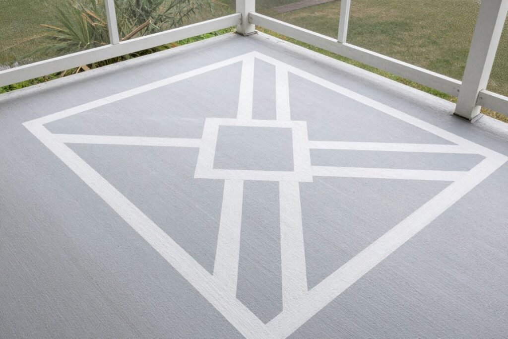A painted concrete floor on a screened porch with a stenciled pattern