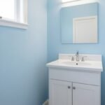 Bathroom with freshly painted light blue walls and white trim
