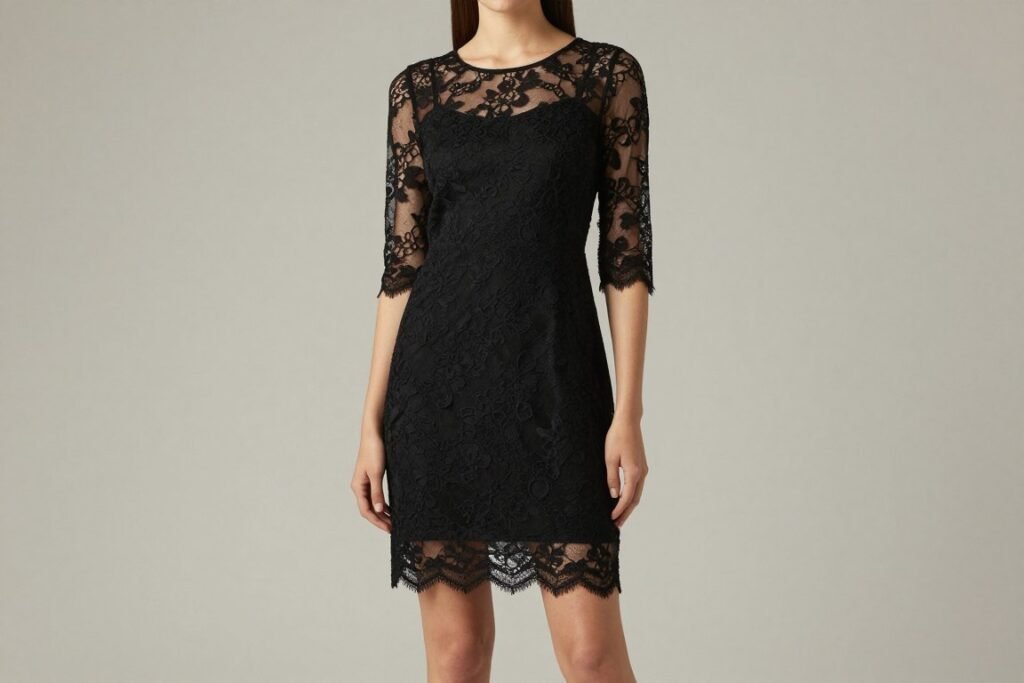 Black cocktail dress with sheer lace sleeves and scalloped hem