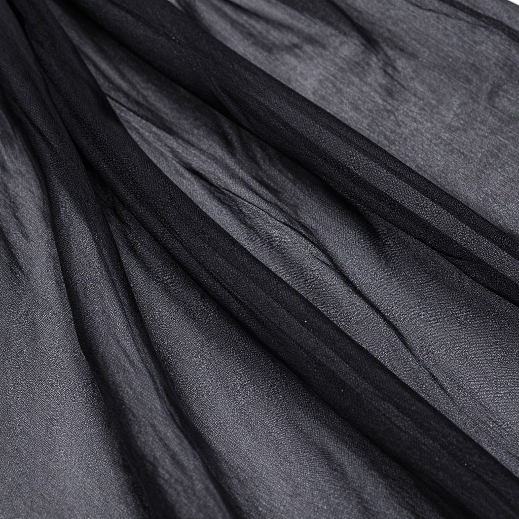 Close-up of black chiffon fabric showing its light, airy texture