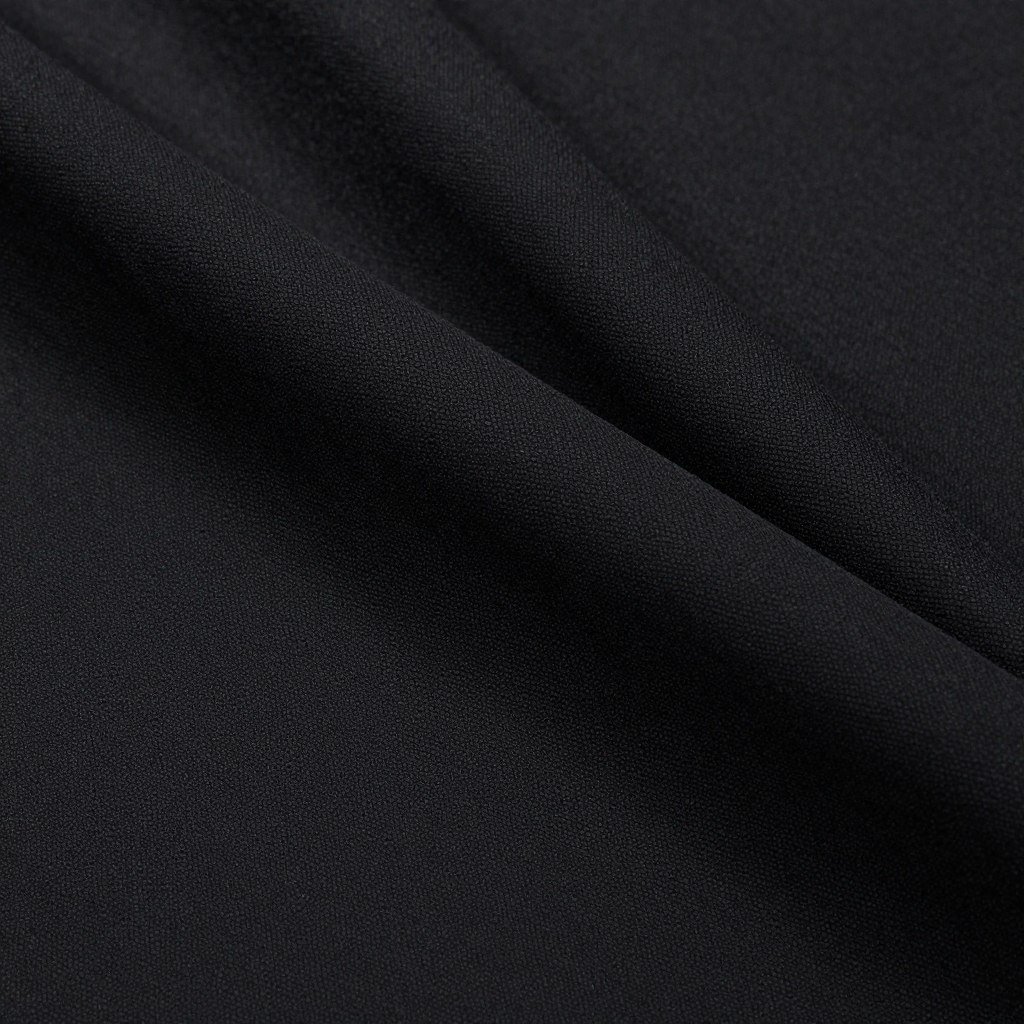 Close-up of black crepe fabric showing its textured, matte finish