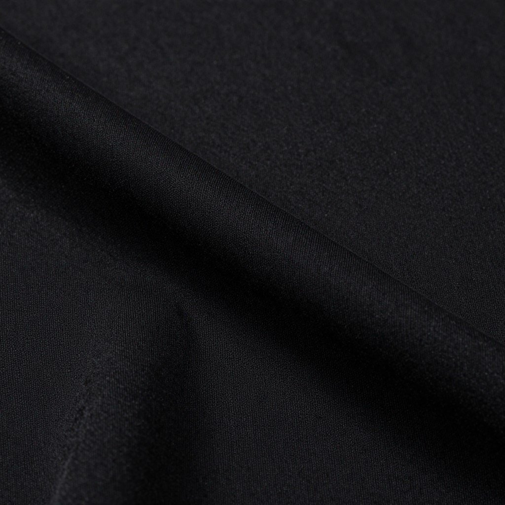 Close-up of black jersey fabric showing its stretchy, comfortable texture