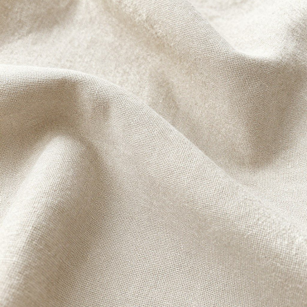 Close-up of linen fabric showing its natural texture and breathable weave