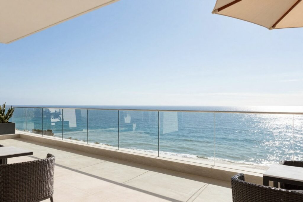 Frameless glass balcony railing design with ocean view