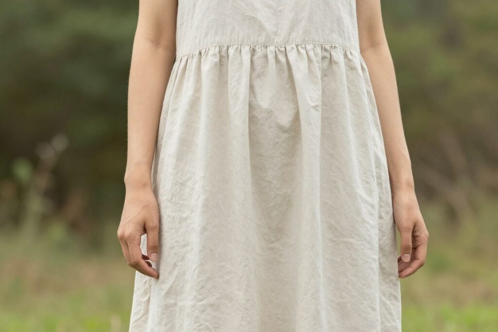 Woman in organic cotton long summer dress in natural setting