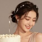 Beautiful woman with elegant birthday hairstyle wearing a sparkly dress