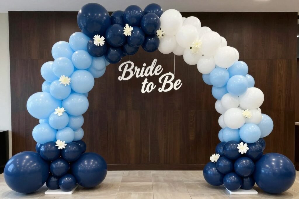Blue ombre balloon arch with white accents and bride to be sign