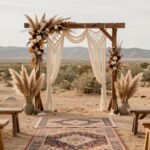 Bohemian wedding ceremony setup with macrame backdrop, pampas grass arrangements, and vintage rugs lining the aisle