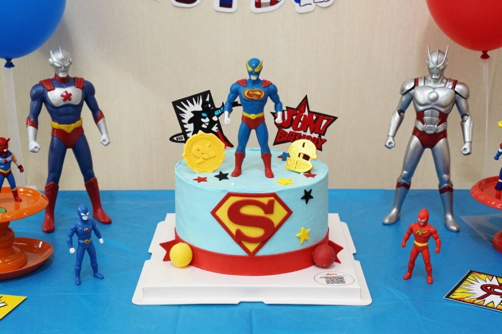 Colorful children's themed birthday cake table with character elements and playful decorations