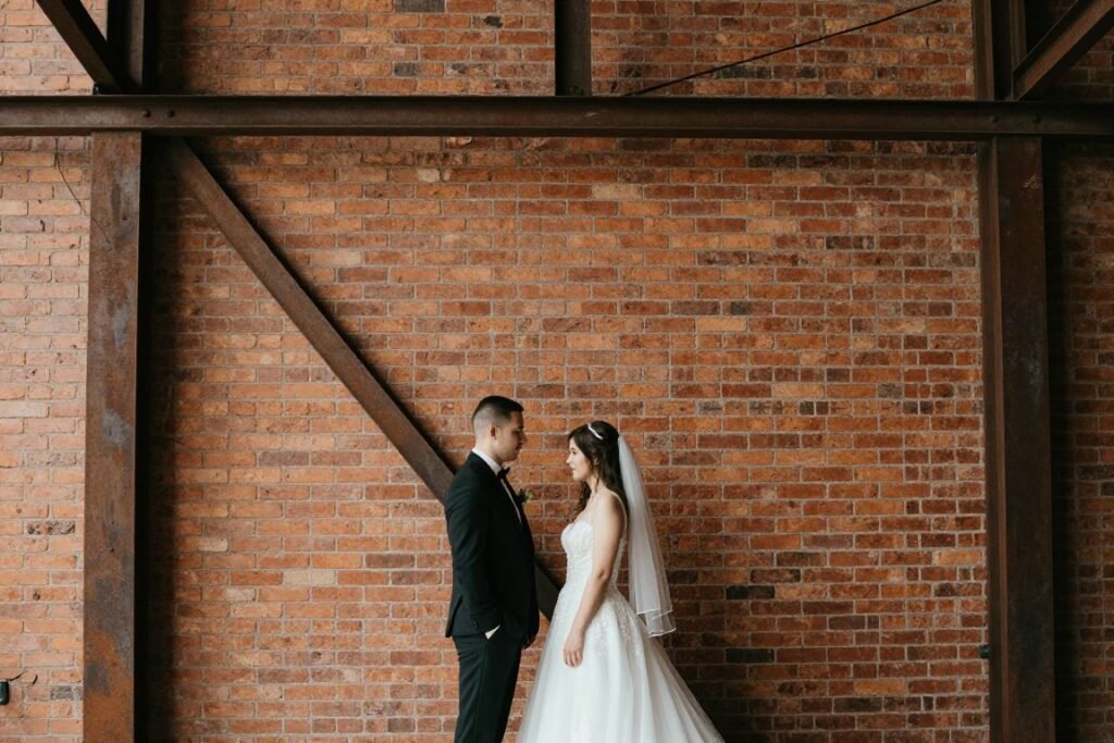 Couple against industrial brick wall with metal details
