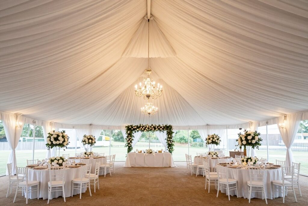 Decorated wedding tent with draped fabric ceiling