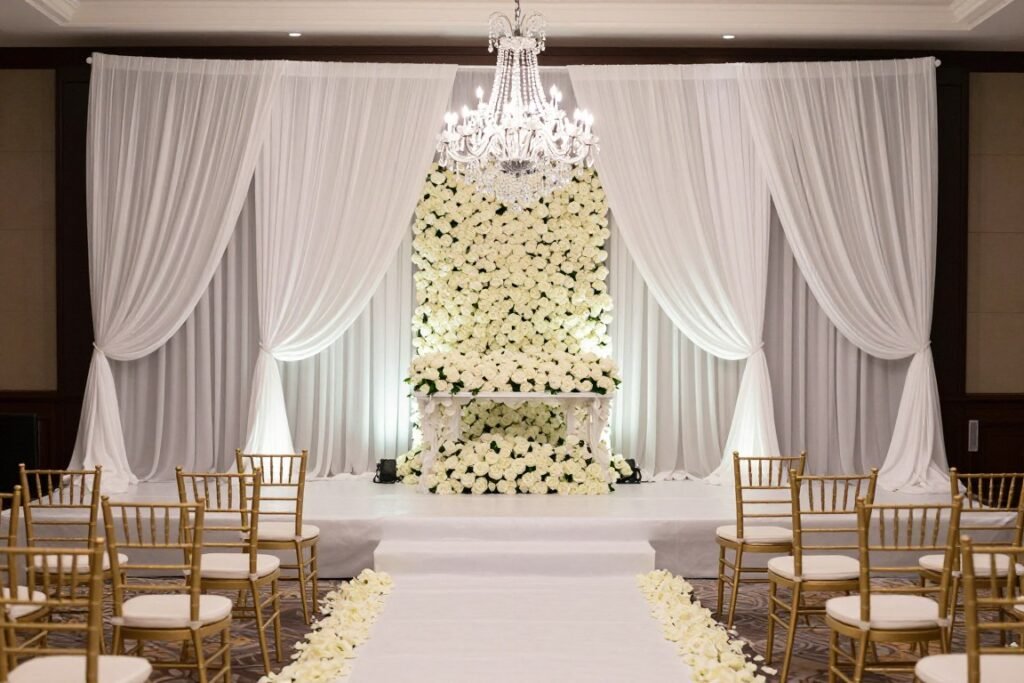 Elegant ballroom wedding ceremony with dramatic backdrop and lighting