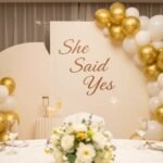 Elegant engagement party setup with gold and white decorations including balloons, banners, and table settings