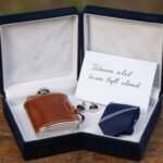 Elegant groomsmen proposal box with personalized items and gift accessories displayed on wooden table