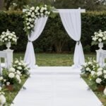 Elegant wedding aisle decorated with white flowers and greenery for an outdoor ceremony