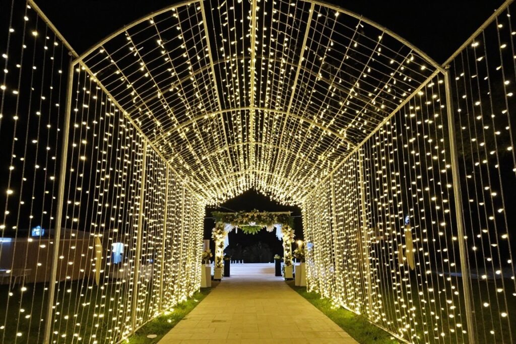 Fairy light tunnel creating a magical wedding entrance pathway