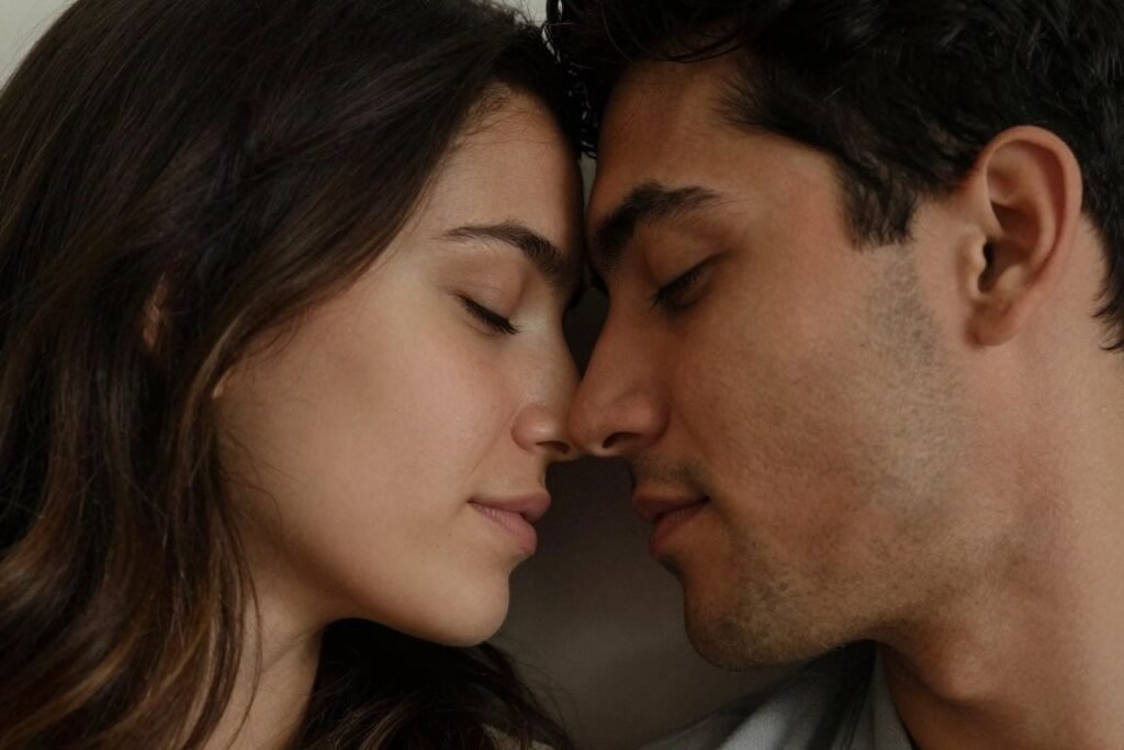 Intimate couple pose with foreheads touching during anniversary photoshoot Intimate couple pose with foreheads touching during anniversary photoshoot