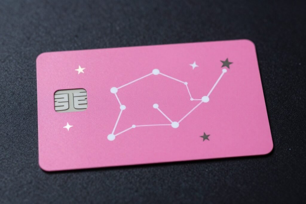 Pink cashapp card decorated with constellation and zodiac symbols