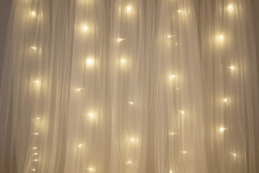 Tulle backdrop decoration with fairy lights creating a magical atmosphere for an evening event