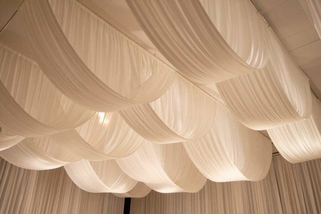 Wedding venue with billowing white chiffon drapery creating a romantic atmosphere Wedding venue with billowing white chiffon drapery creating a romantic atmosphere