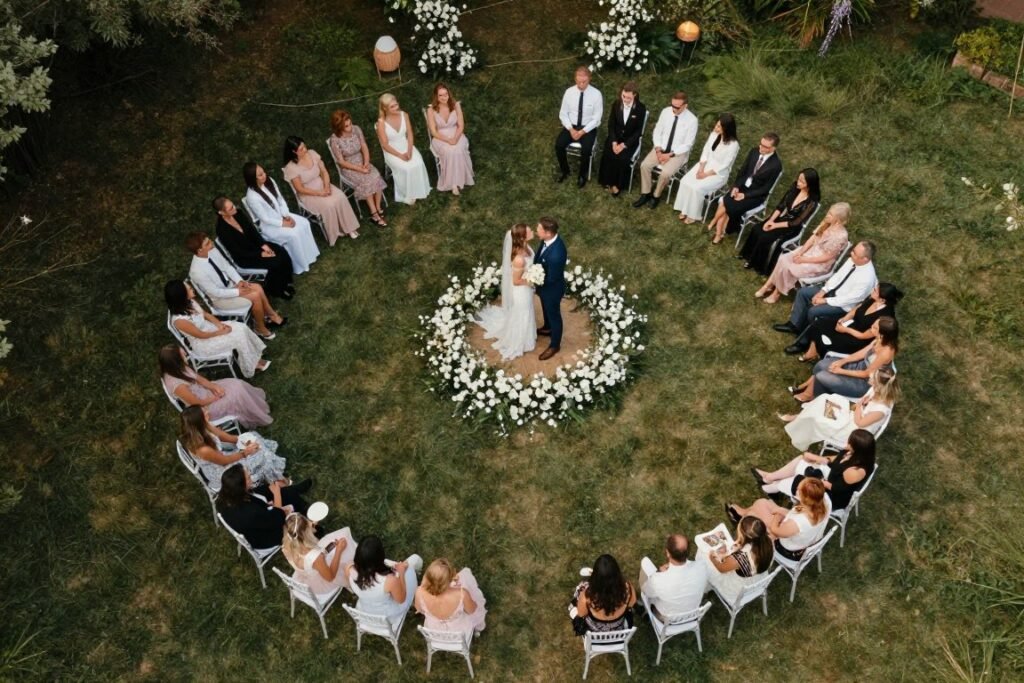 circular micro wedding ceremony seating with couple in center surrounded by guests