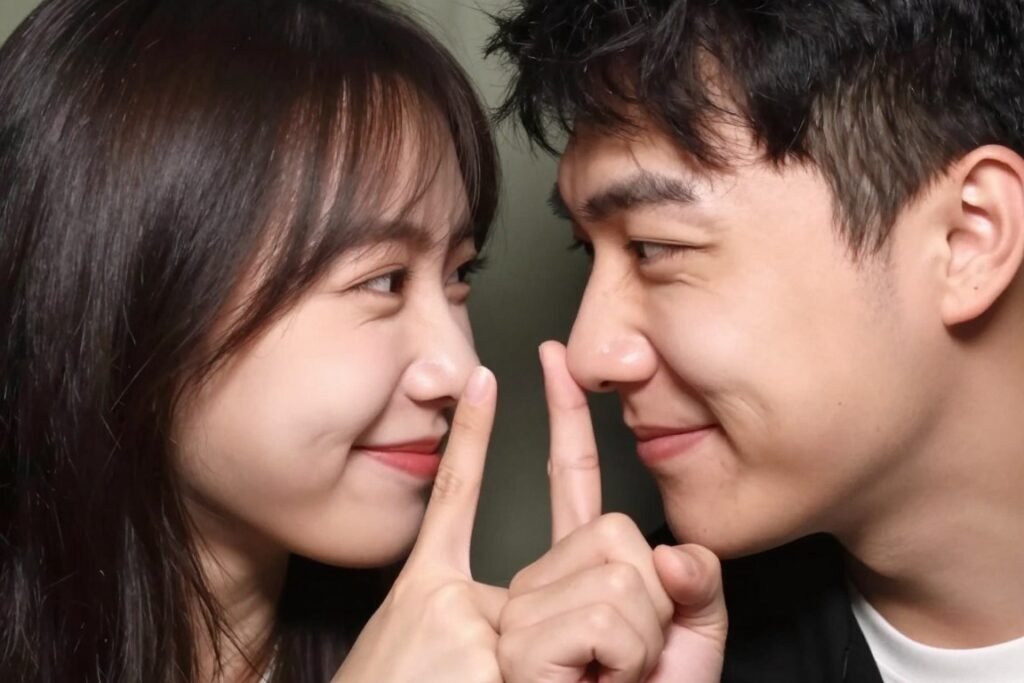 couple booping each other's noses playfully in cute photobooth pose