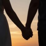 Private Engagement Proposal Ideas That Create Unforgettable Intimate Moments couple holding hands during private engagement proposal at sunset