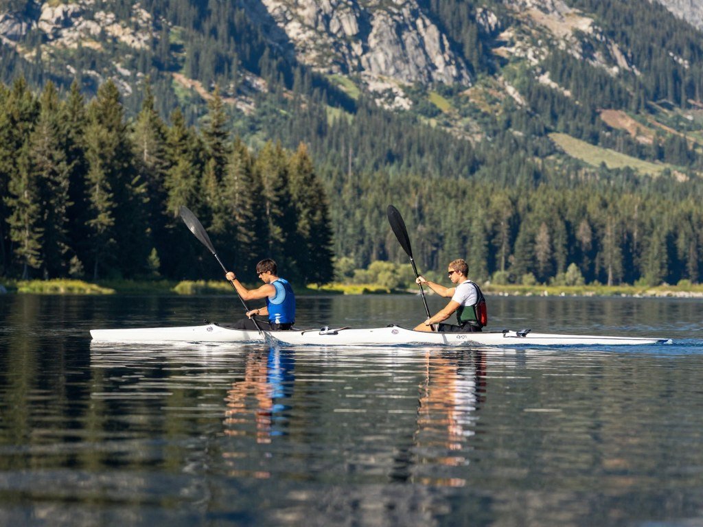 couple kayaking together on peaceful lake water