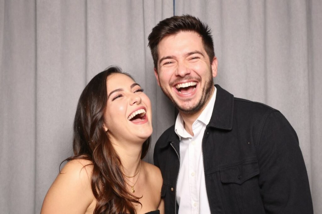couple laughing and having fun during photobooth session