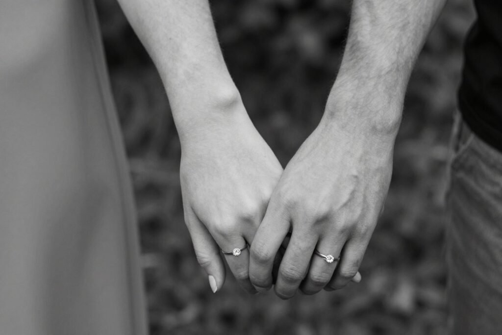 couple showing their matching wedding ring tattoos on fingers instead of traditional bands