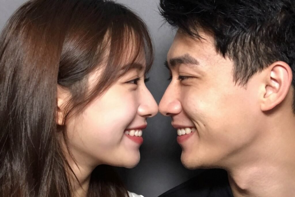 couple touching noses and smiling in sweet eskimo kiss photobooth pose