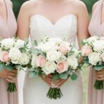 elegant bridesmaids bouquets held by bridesmaids in pastel dresses outdoors