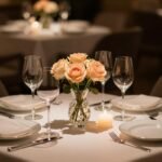 elegant romantic dinner table setting with candles and flowers for anniversary celebration