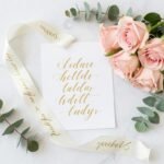 elegant wedding color palette with soft blush pink, ivory, and gold accents displayed with flowers and decor