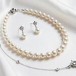 elegant wedding jewelry ideas for bride displayed on white silk fabric