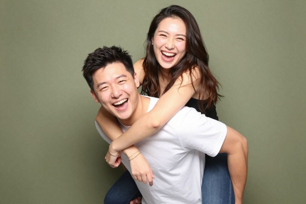 man giving woman piggyback ride in fun photobooth pose