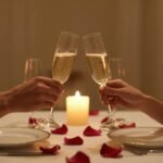 romantic couple celebrating anniversary with candles and champagne