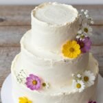 stunning wildflower cake with buttercream flowers and fresh blooms