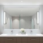 Modern bathroom vanity lighting illuminating a double sink with mirror