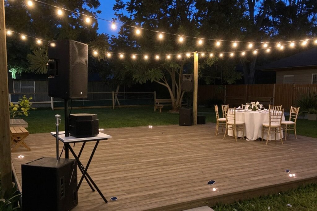 backyard wedding dance floor area with DIY music setup and decorations