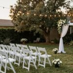 beautiful backyard wedding setup with string lights and simple elegant decorations on a budget