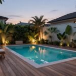 beautiful small backyard pool with modern deck and lounge seating area surrounded by tropical landscaping