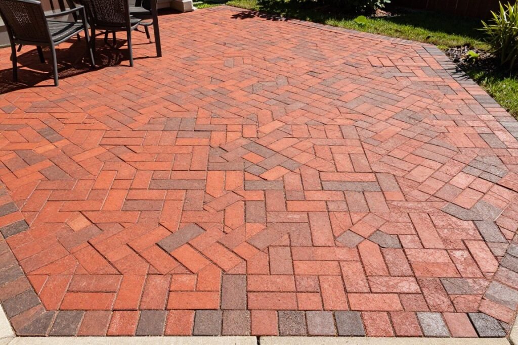finished brick paver patio with herringbone pattern and border